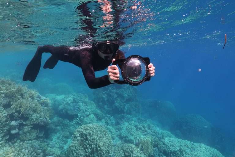 Author using GoPro dome port while snorkeling